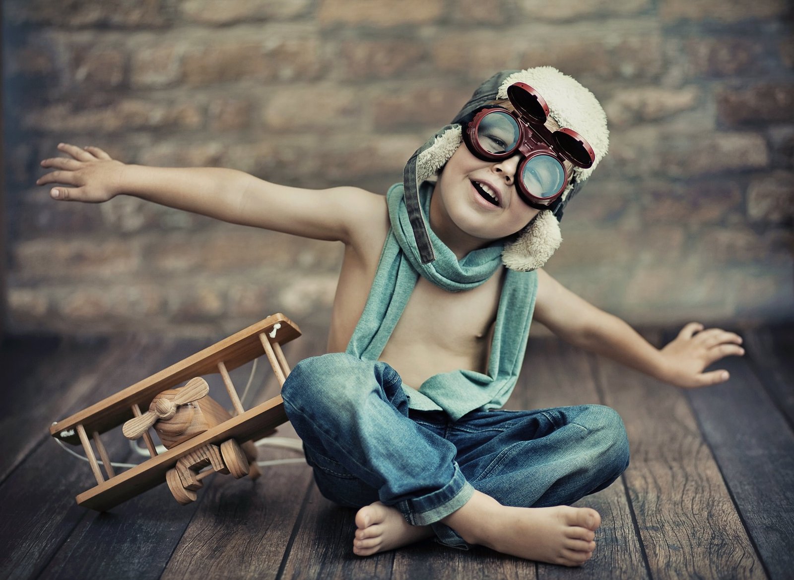 Young aviator with a wooden toy plane